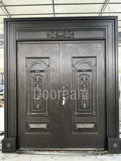 Carved bronze double door with classical panels, photographed on our floor