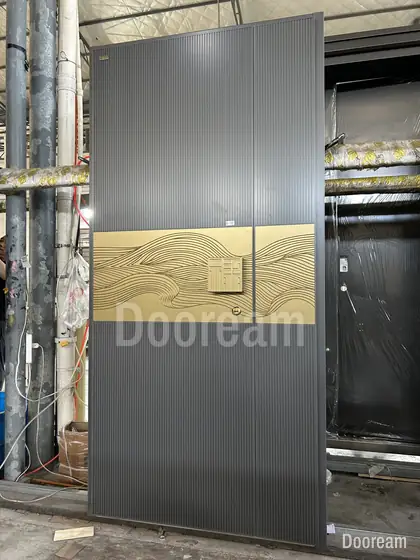 Grey door with a gold wave band, photographed on our floor