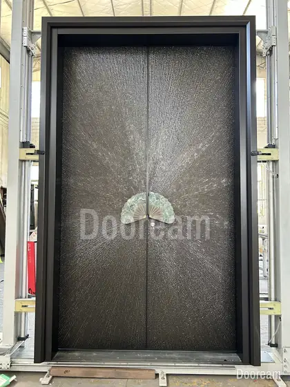 Dark double door with a fan medallion, photographed on our floor