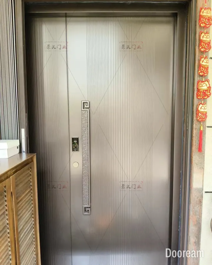 Champagne fluted single door with an ornate fret-pattern pull handle, installed at a client's home