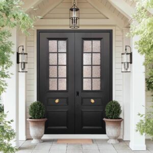 Classical matte black French-style double entrance door with 10-pane textured glass panels, featuring two symmetrical gold-finish knobs, installed in a white gabled porch with matching lanterns.