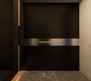 A tall, floor-to-ceiling black fluted armored door seamlessly integrated into a matching fluted wall, featuring a horizontal brushed steel smart beam with a glowing blue LED light strip and a marble floor.