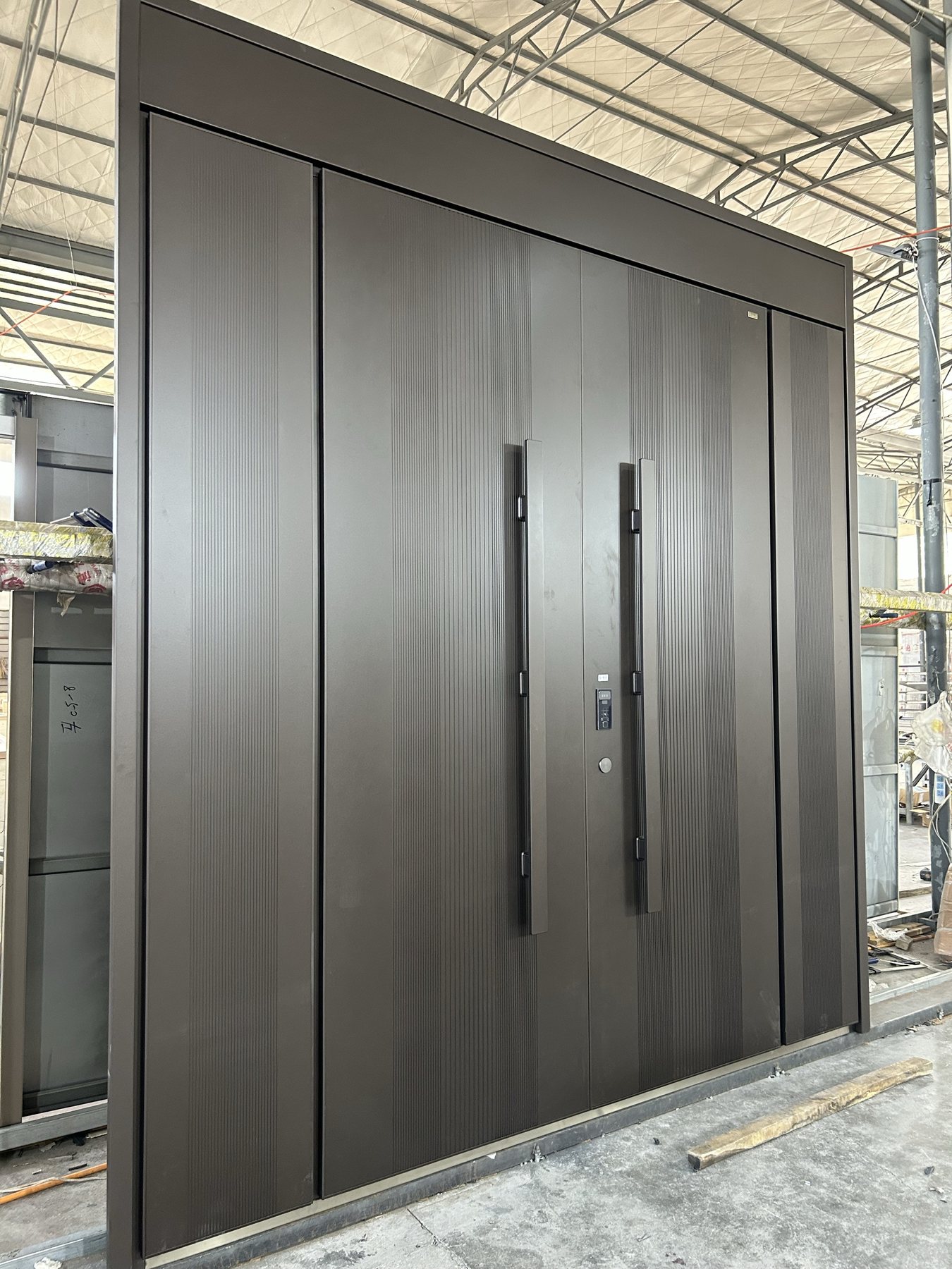 Large custom security style entrance door shown during factory production