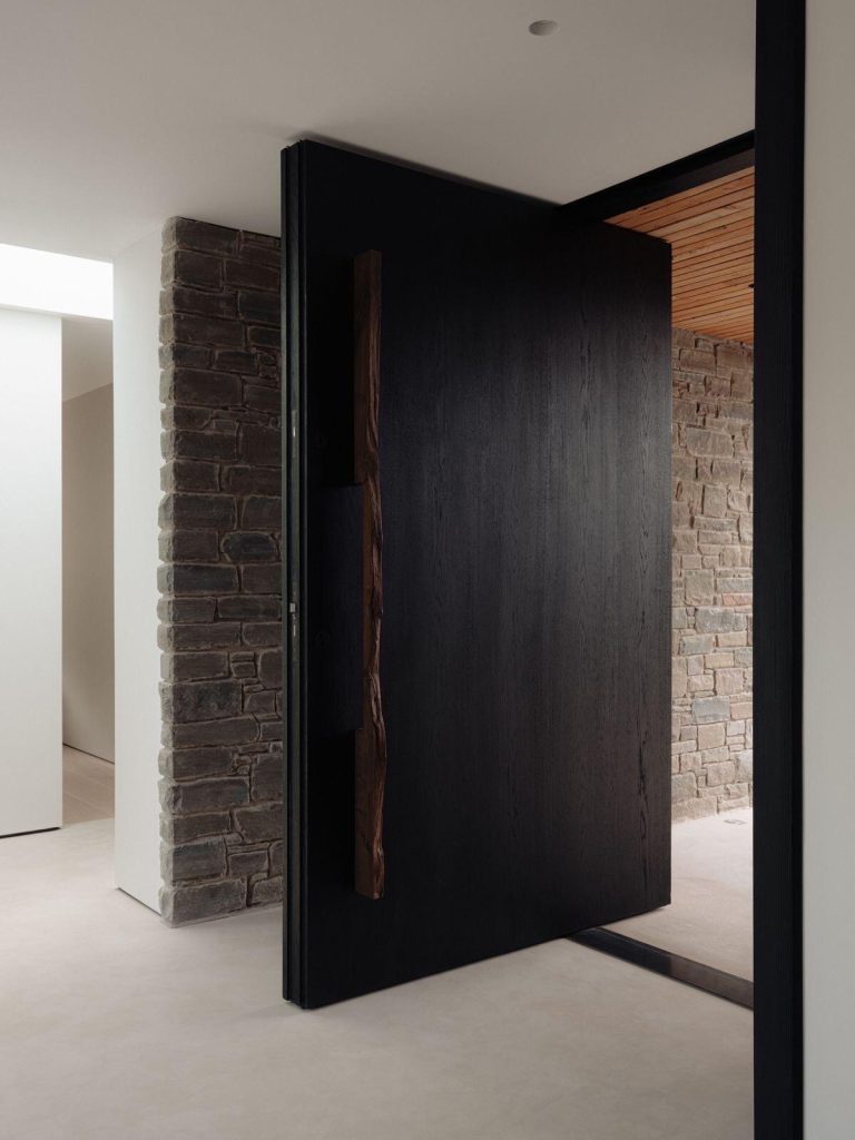 Charcoal door with irregular warm-wood-tone pull